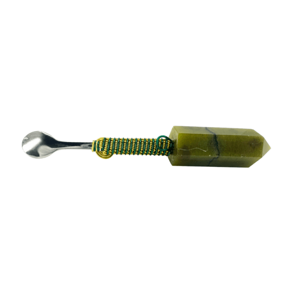 Green crystal spoon with metal handle.