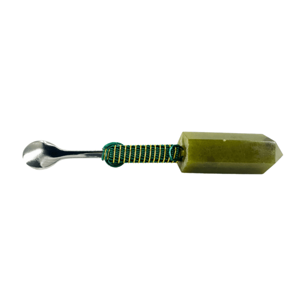 Green crystal spoon with metal handle.